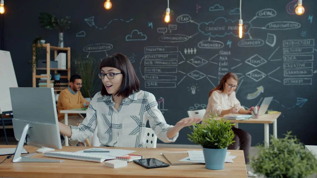 Person coding on a laptop during a video conference, showcasing remote work.